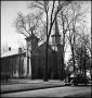 Photograph: [People standing outside of a brick church]