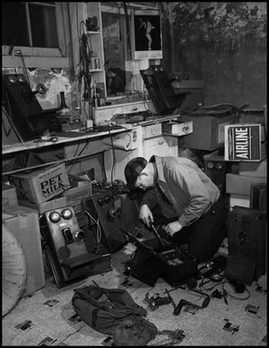 Primary view of object titled '[Man repairing a telephone]'.