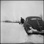 Photograph: [Man checking his car in the snow, 2]