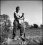 Photograph: [Young man shoveling dirt, 3]