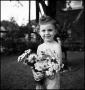 Photograph: [Portrait of a little girl holding a bouquet of flowers, 3]