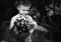 Photograph: [Portrait of a little girl holding a bouquet of flowers, 4]