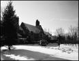 Photograph: [Woman standing on a snowy driveway]