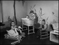 Photograph: [Four children playing in a nursery]