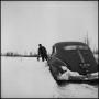 Photograph: [Man checking his car in the snow]