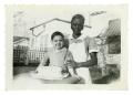 Photograph: [Woman and Bob Cuellar with cake]