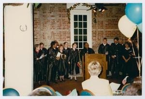Primary view of object titled '[Herman Totten on stage with a choir of UNT librarians, 1997]'.