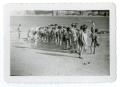 Primary view of [Bob Cuellar and other boys in forming a line in front of a lake]
