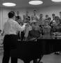Photograph: [Richard Lamb directing the chapel choir during rehearsal]