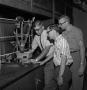 Photograph: [Three male chemistry students conducting research]