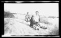 Photograph: [Irene, Byrd III, and John Williams sitting in the sand]