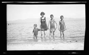 Primary view of object titled '[Irene Williams and her sons standing in water on a shoreline]'.