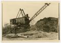 Photograph: [A man standing in front of a crane]