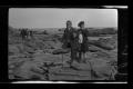 Photograph: [Byrd III, and John Williams standing on a rocky shoreline]