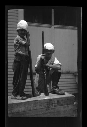Primary view of object titled '[Byrd III and Charles Williams playing with toy guns]'.