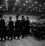 Photograph: [Young men in line to receive diplomas]