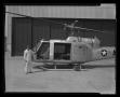 Photograph: [Bell employee holding the door open to the YH-40 helicopter]