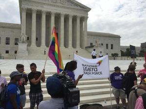 Primary view of object titled '[Photo taken at the U.S. Supreme Court on Marriage Equality Day, a sign says "National LGBTQ Task Force]'.