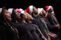 Photograph: [Blurry photo of choir members singing]