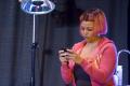 Photograph: [Kim Fields on Stage with Cell Phone]