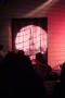 Primary view of [Audience and spotlight on curtain doorway]