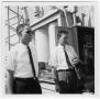 Photograph: Two Unidentified Men Talking at a Power Plant