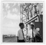 Photograph: Two Unidentified Men Talking at a Power Plant