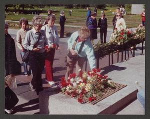Primary view of object titled '[Women with Flowers at Memorial]'.