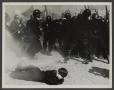 Photograph: [Man on Ground Behind Police]