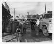 Photograph: [Cleaning Crew in Front of Produce Store]