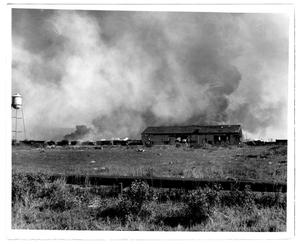 Primary view of object titled '[A water tower, pipeline, damaged structure and train cars after the 1947 Texas City Disaster]'.