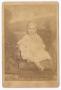Photograph: [Unknown Young Girl Seated in Fabric Chair]