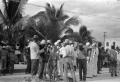 Photograph: [Sailors and Civilians in Front of Palm Trees]