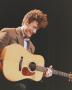 Photograph: [Lyle Lovett Holding a Guitar and Smiling]
