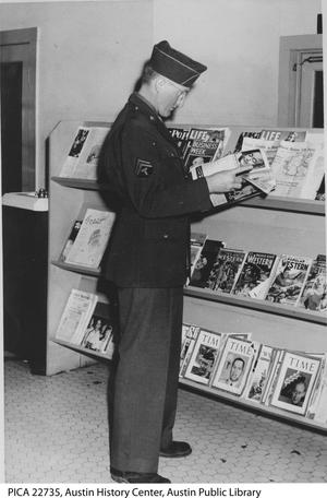 Primary view of object titled '[Soldier Reading at Magazine Stand]'.