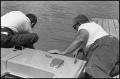 Photograph: [Men Examine Boat End]