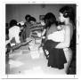 Thumbnail image of item number 1 in: 'Nurse Oligar checking student immunization records'.