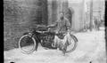 Photograph: [Man Standing with Motorcycle and Fish #1]