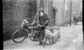 Photograph: [Man Standing With Motorcycle and Fish #2]