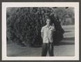 Primary view of [Man Standing in Front of a Bush]