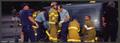 Photograph: [Close-up of Firefighters Working on Overturned Vehicle]