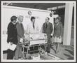 Photograph: [Photograph of Five People With an Incubator]