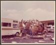 Photograph: [Man Stands Outside of Destroyed Camper]