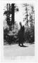 Primary view of [Col. Hugh B. Moore walking along a dirt road]