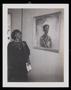 Photograph: [A Woman Looking at a Portrait]
