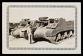 Photograph: [Soldier Standing Next to Tanks]