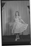 Photograph: [Betty Schmidt Posing in Front of Curtain]