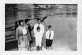 Photograph: [A group of Czigans and Moers standing in front of a body of water.]