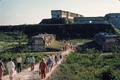 Photograph: [Tourists Walking Toward Mayan Ruins]