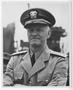 Photograph: [Admiral Chester W. Nimitz Stands with Arms Crossed]